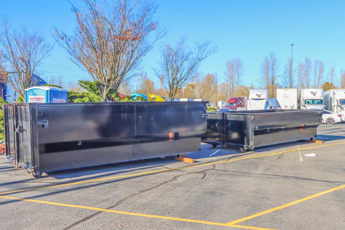 Professional dumpster rental service with roll-off container on residential driveway in Genesee